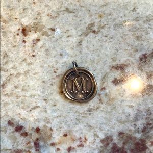 Waxing poetic “m” charm. Excellent used condition.